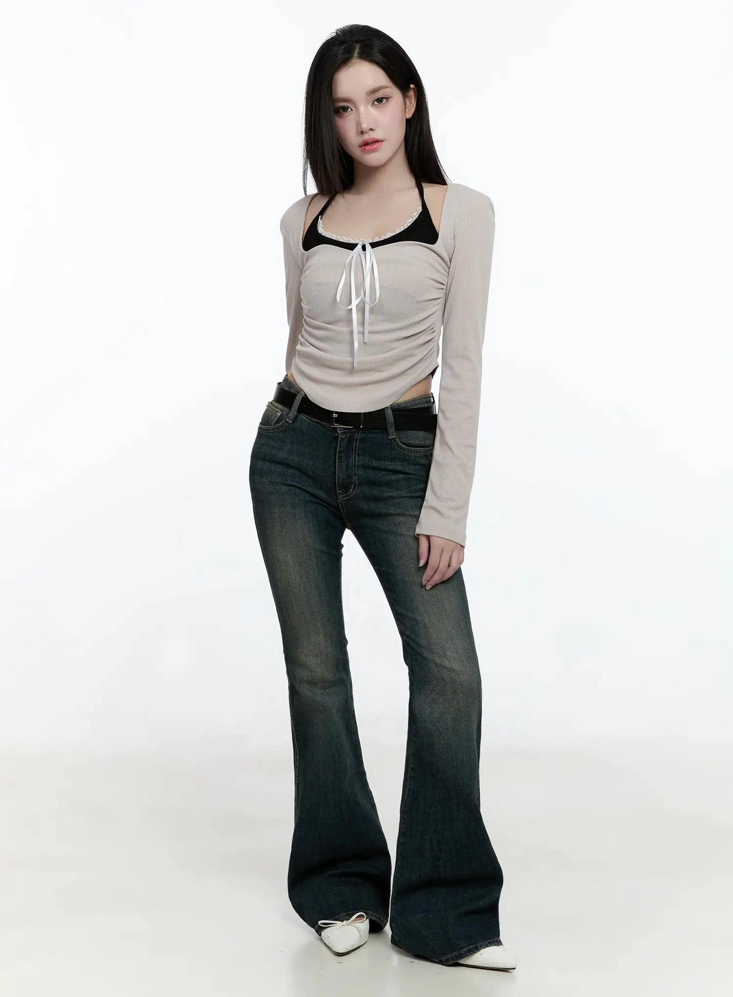 Karla Vintage Logo Hip Pad Flare Jeans IO520 in washed dark blue, front full-body on model, slim fit flare silhouette, paired with beige ruched top and white flats.