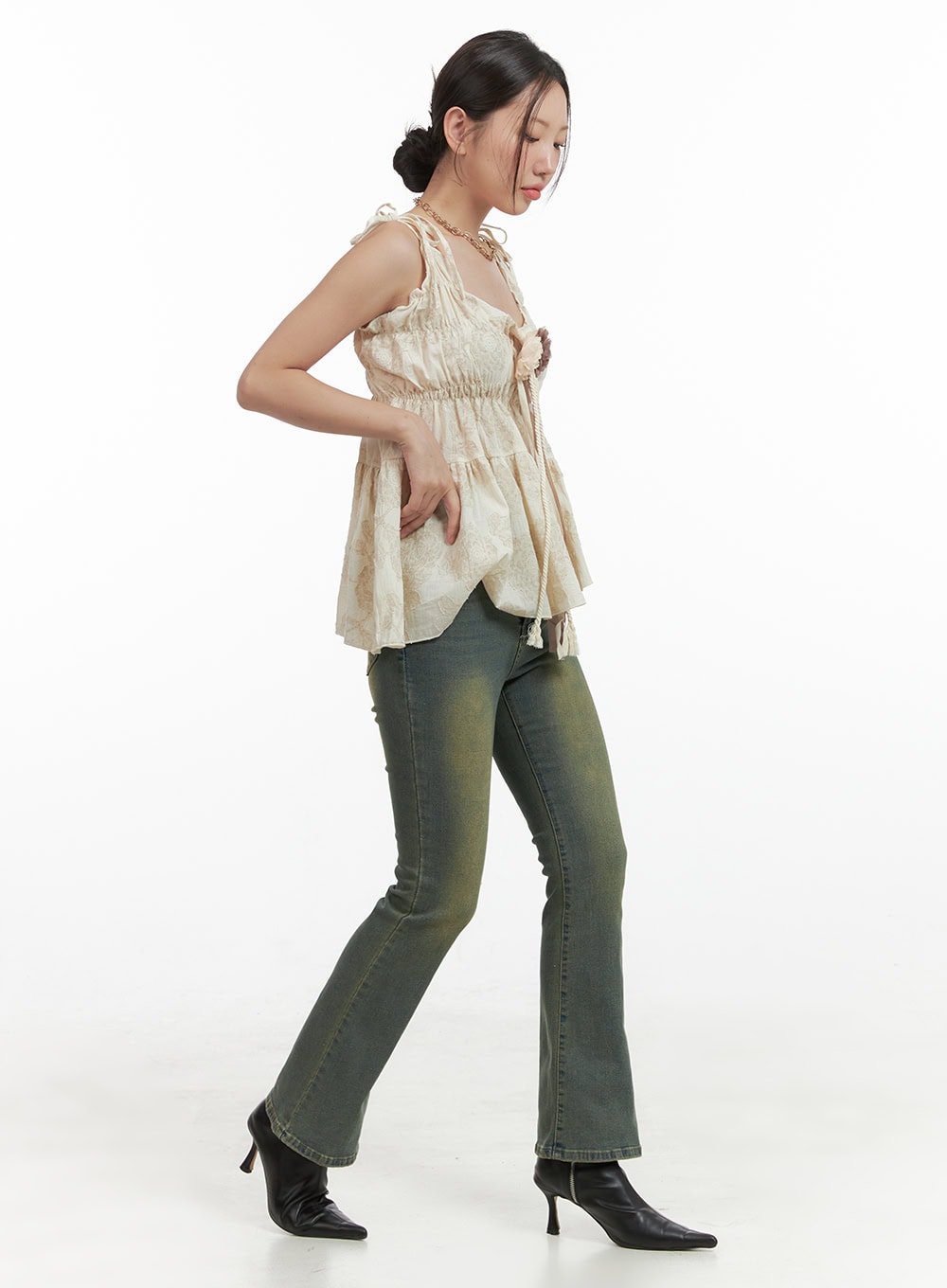 Pamela Belt Bootcut Jeans OG407 in Yellow, side view on model mid-stride, washed cotton bootcut silhouette showing slim thigh and flared hem, paired with cream cami and black heels.