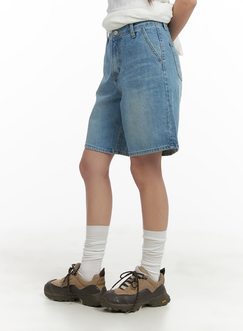 Washed Wide Leg Jorts CA409 in blue, side-back view on model, wide-leg silhouette with faded wash, high waist, paired with white top and hiking sneakers.