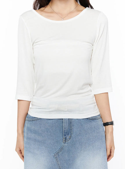 Sheer Three-Quarter Sleeve Top CU522 in white, close-up front torso shot on model, round neckline and soft sheer fabric with subtle ruching, tucked into light blue denim skirt.