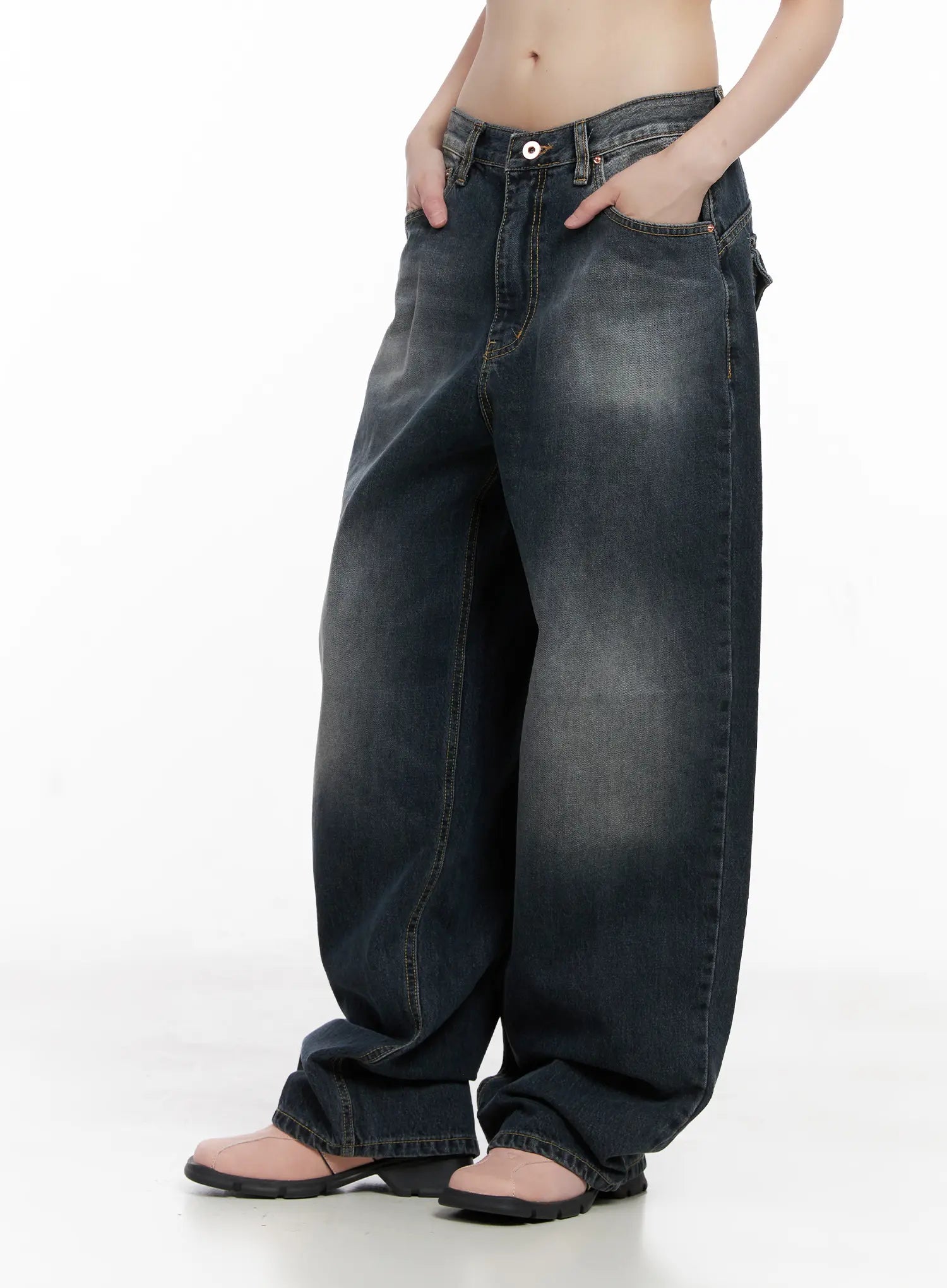 Celi Vintage Wash Wide-Leg Jeans CG515 in dark vintage wash, front waist close-up on model, low-rise waistband with button closure and front pockets, baggy cotton denim.