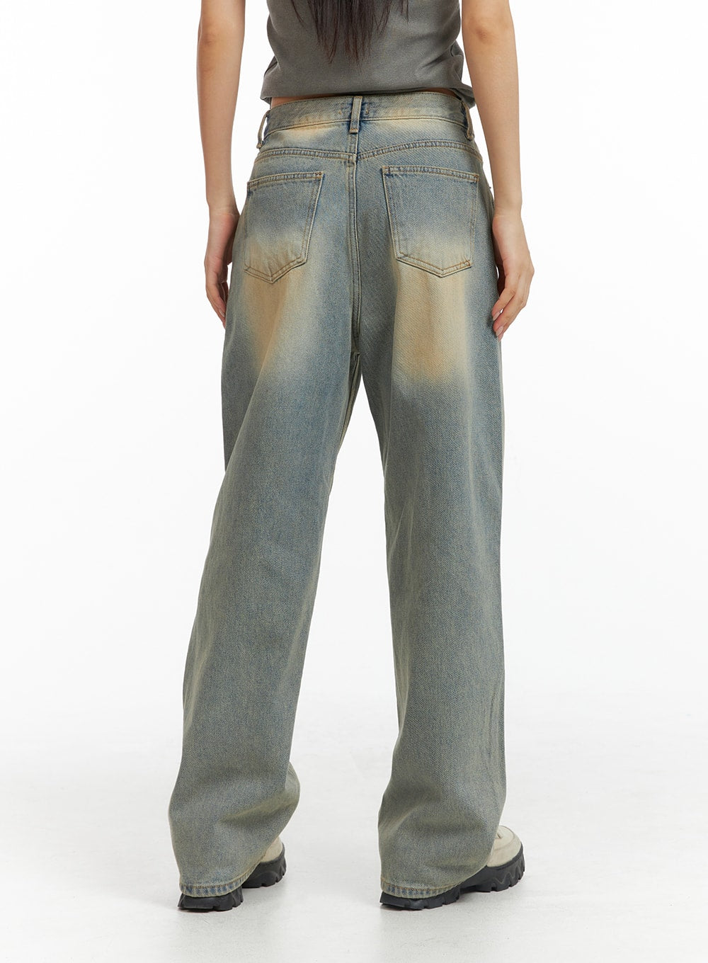 Dark Wash Jeans CF303 in blue, back view on model, wide-leg cotton denim showing dual back pockets and sandy washed fading at seat, paired with grey top.