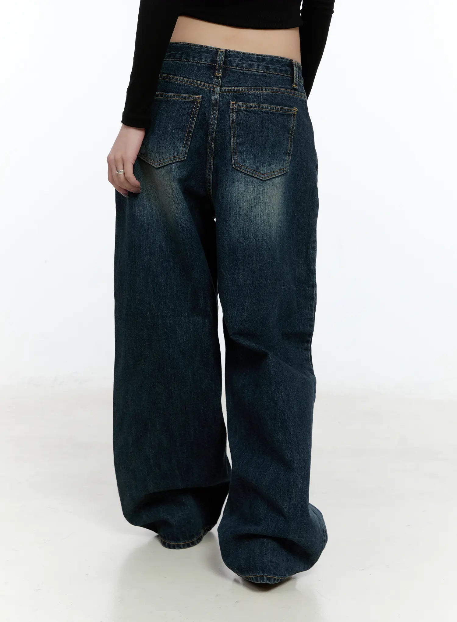 Hunter Washed Wide Leg Jeans CN517 in dark blue, back view on model, revealing dual back patch pockets with topstitching and washed cotton denim, worn with black crop top.