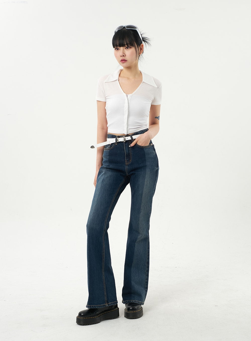 Dark Wash Bootcut Jeans CA328 in dark blue, front full-body angled view on model, slim washed denim with subtle fade, white belt, bootcut silhouette elongating the leg.