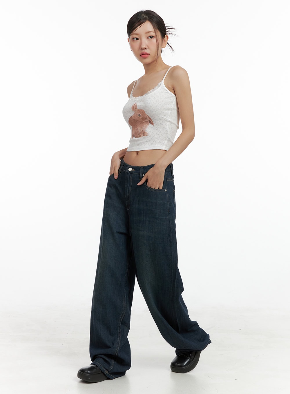 Dark Wash Wide Jeans CU305 in dark blue, three-quarter side angle on model, low-rise wide leg jeans with subtle fading, paired with white lace crop cami and black platform loafers.