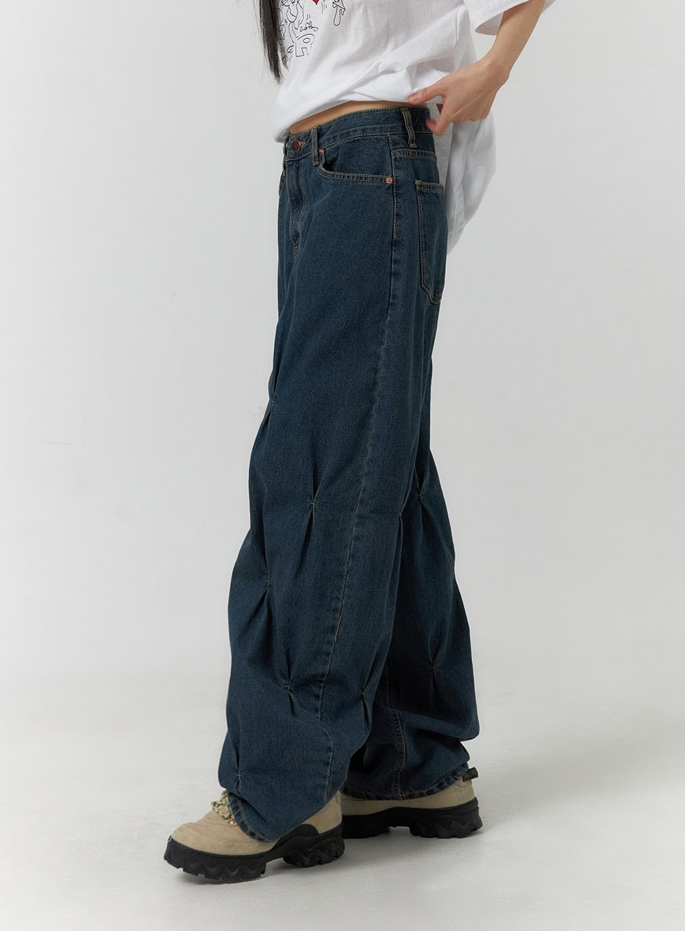 Quilted Wide Leg Denim CF406 in dark blue, side view on model, showing quilted pintuck seam detail running full leg length, paired with white graphic tee and chunky sneakers.