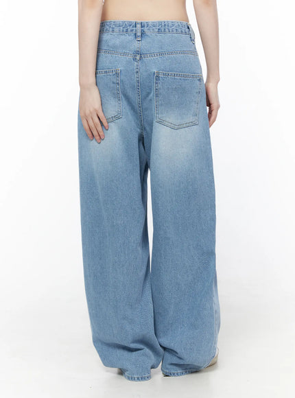 Nella Wide Leg Jeans CU519 in blue, back view on model, light-wash denim featuring two back patch pockets and wide leg silhouette with subtle fading.