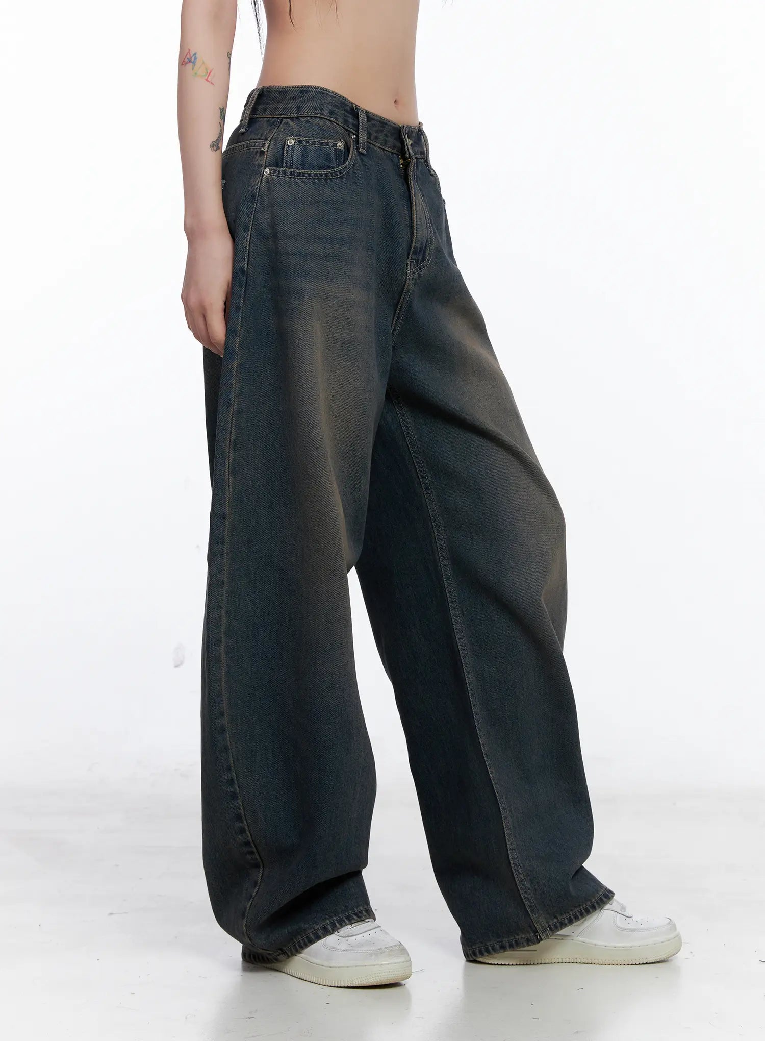 Ocean Faded Balloon Fit Jeans CS510 in washed dark indigo, side view on model, exaggerated wide-leg balloon volume and long length shown, paired with white sneakers.