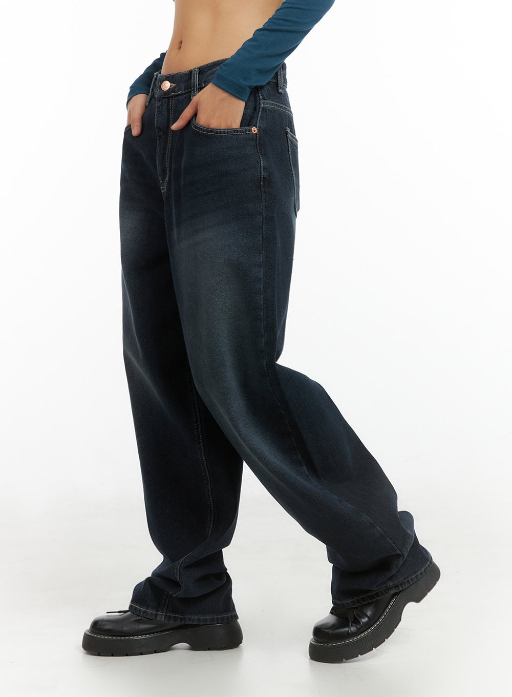 Evelyn Washed Baggy Jeans (Dark Blue) IS402 in dark blue, angled side shot from waist down, wide baggy leg washed denim with visible contrast seams, hand resting in front pocket.
