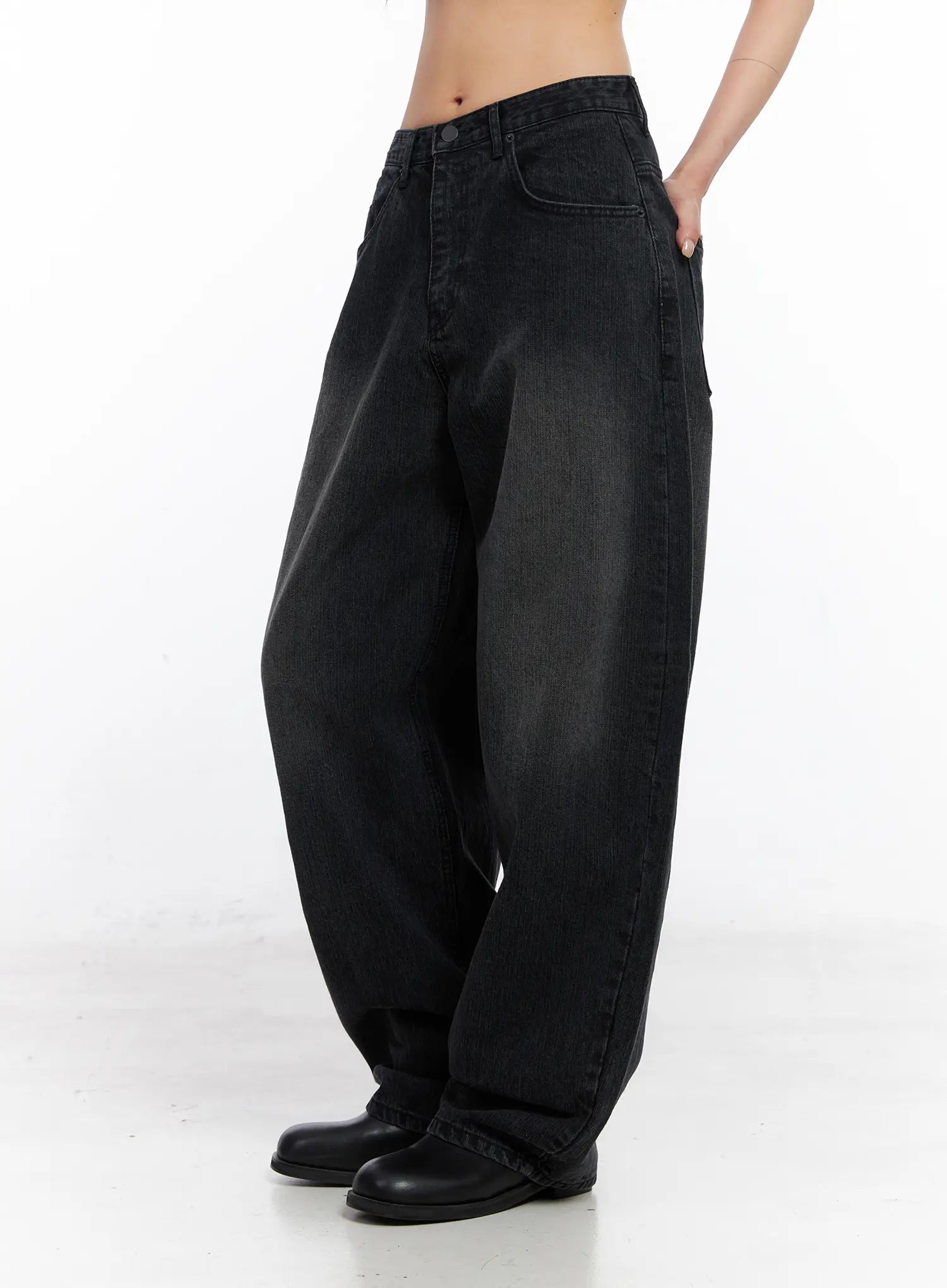 Ivey Washed Baggy Jeans CC1809 in black, side view on model, highlighting exaggerated wide-leg silhouette, washed cotton denim, low rise waist, hand in pocket.