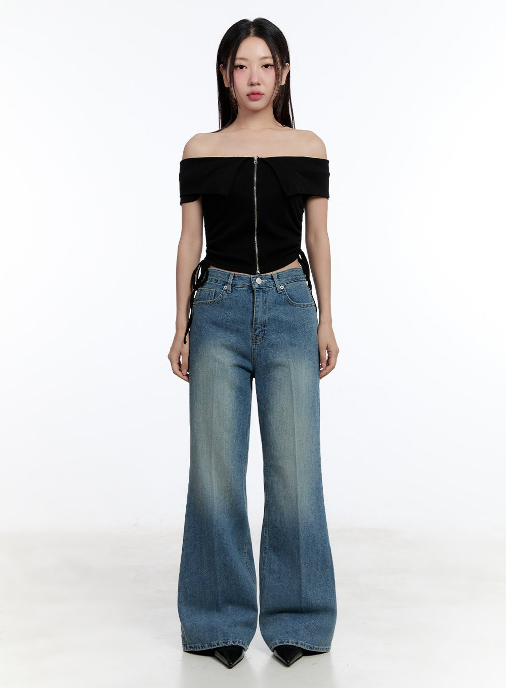 Aliya Washed Bootcut Jeans IU503 in dark blue, full-body straight-on front shot on model, wide-fit washed cotton denim, clean silhouette, styled with black off-shoulder crop top.
