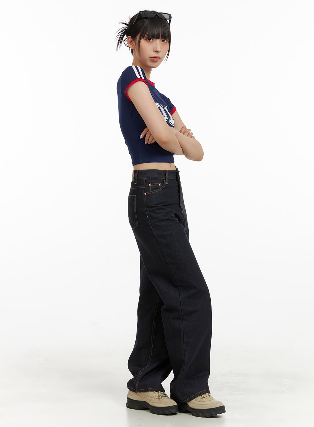 Indigo Stitched Straight Jeans CU424 in dark blue, side profile on model with arms crossed, straight leg length shown from waist to hem with chunky sneakers.