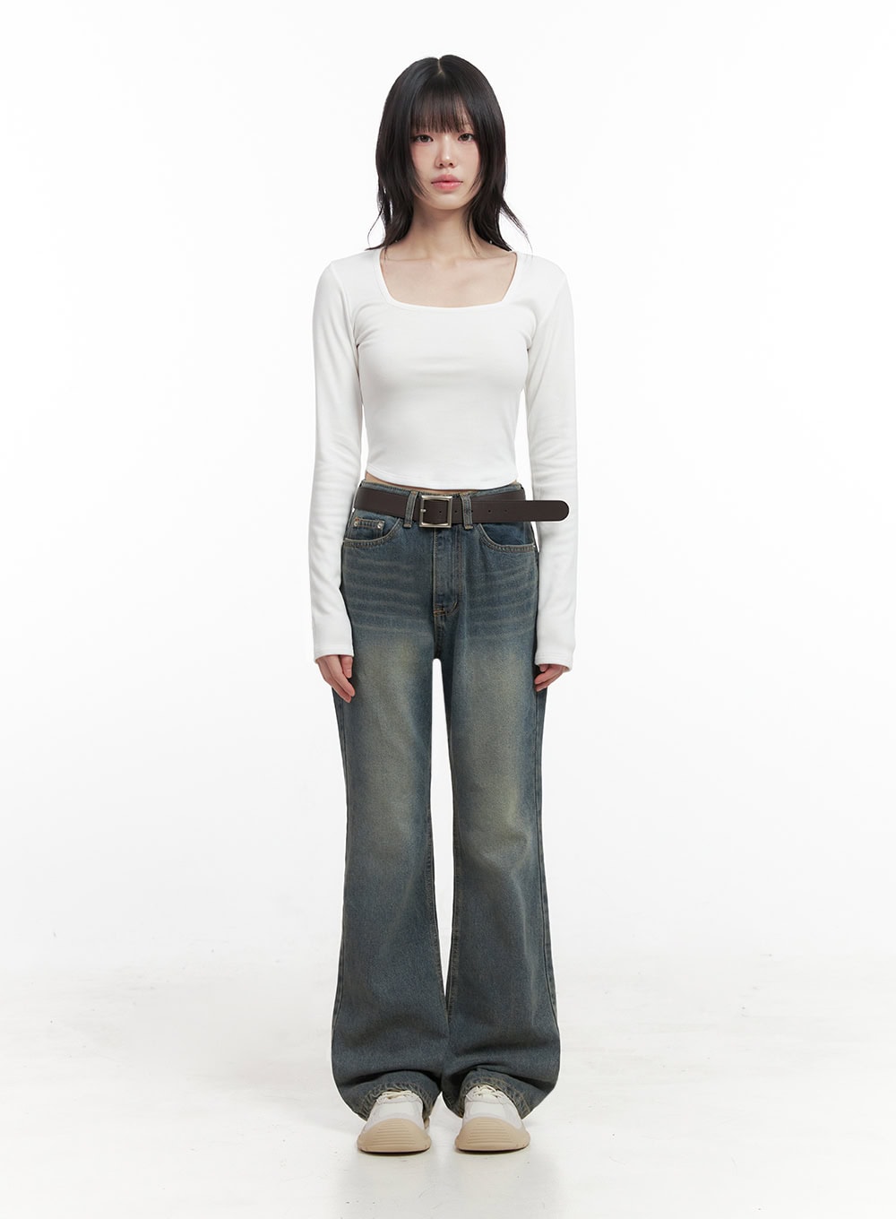 Asher Slimline Washed Bootcut Jeans ID402 in vintage blue, front straight-on full-length shot on model, high-waist with brown square-buckle belt, slimline bootcut leg, paired with white fitted top.