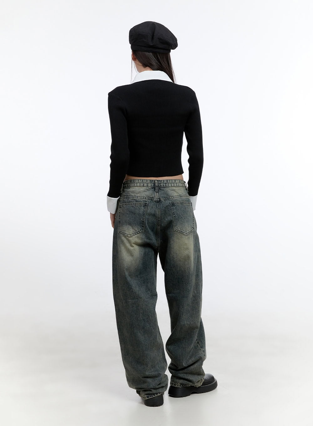 BohoVibe Loose Pants CS406 in dark blue, back full-body on model, showing dual back pockets and heavy washed fading on baggy denim, styled with black beret and ribbed cardigan.