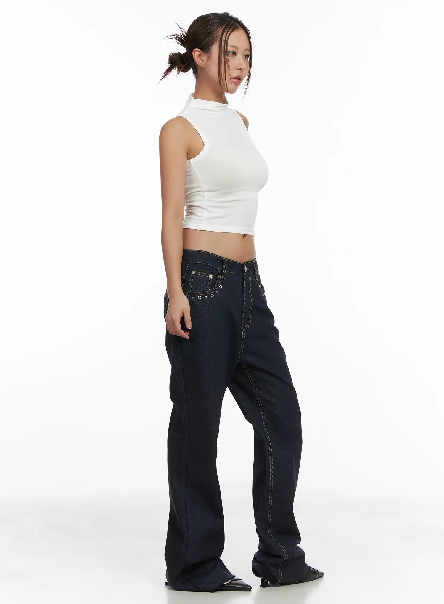 Bunn Non-Fade Eyelet Bootcut Jeans CJ512 in dark blue, side-view full-length shot on model, low-rise waistband with eyelet detail, bootcut flare silhouette, styled with white crop top.