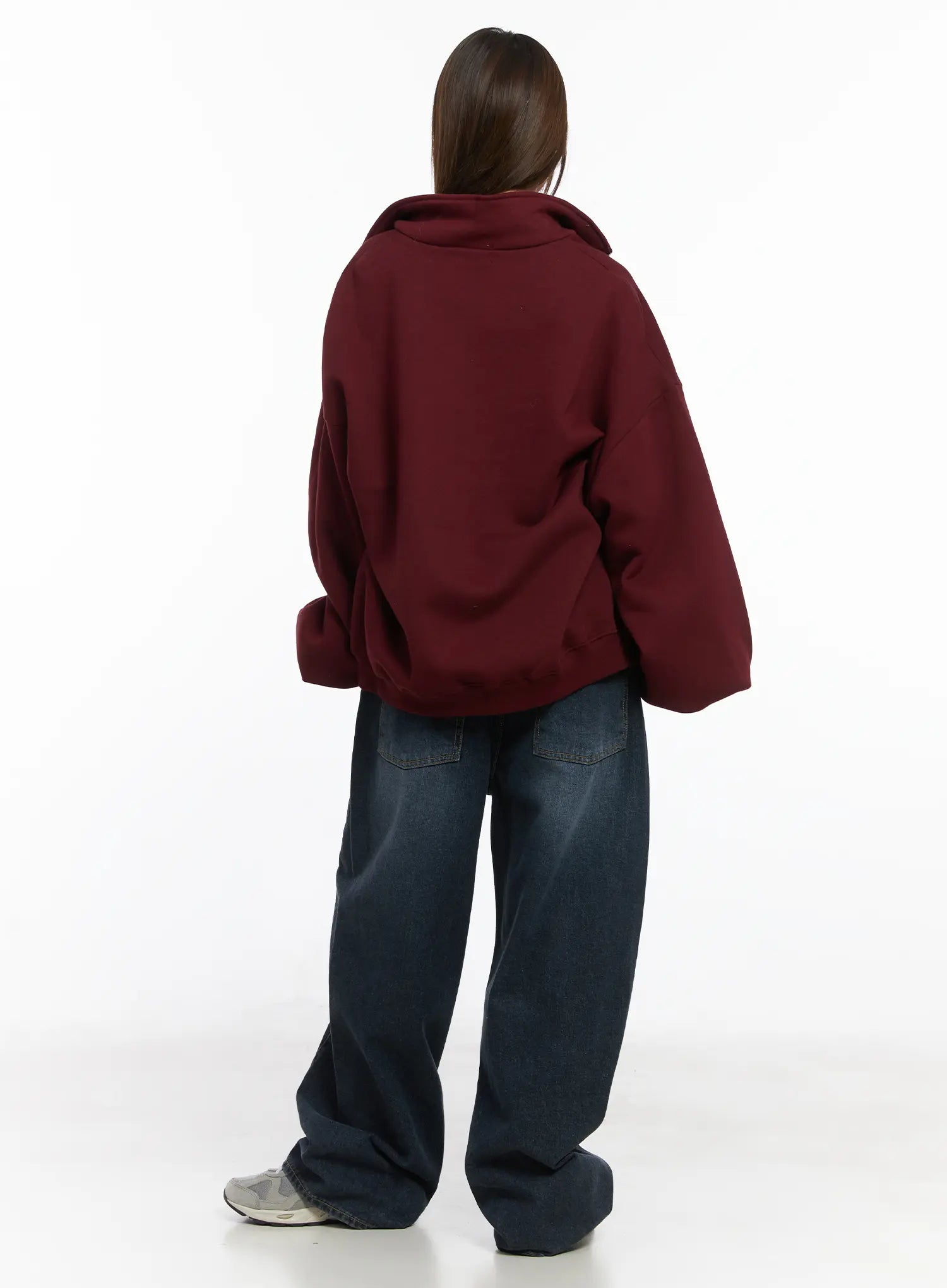 Everly Wide Leg Jeans CJ513 in dark blue, full-body back view on model, wide fit long denim with back patch pockets and washed finish, paired with burgundy oversized sweatshirt and grey sneakers.