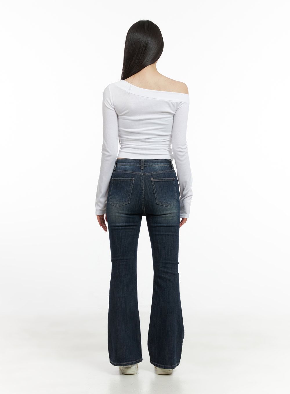 Remy Washed Bootcut Jeans CG420 in blue, full-body back view on model, back pockets and washed denim detail visible, slim fit bootcut flare, styled with white off-shoulder top and sneakers.