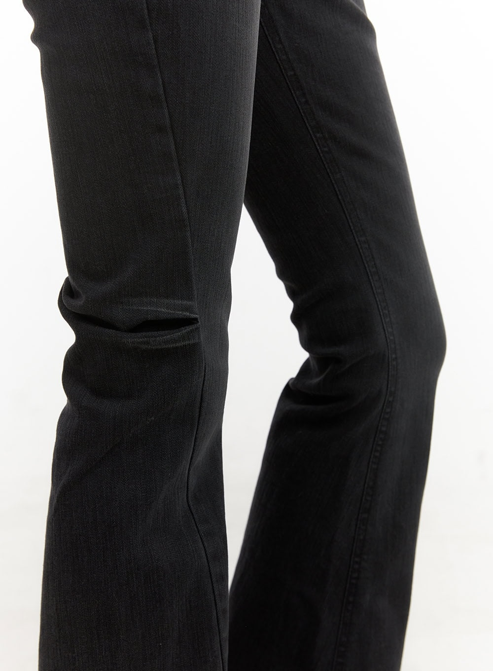 Belle Slim Fit Flared Jeans CD410 in black, close-up detail of knee-to-hem flare, washed denim texture and center seam visible on wide bootcut leg.
