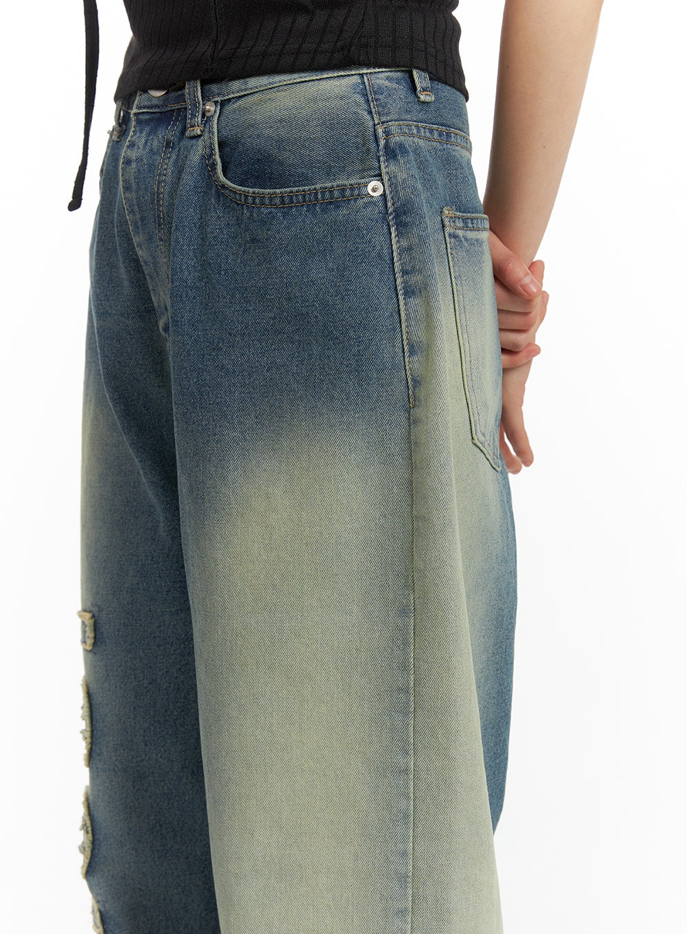 Distressed Baggy Straight Jeans CM413 in blue, back waist close-up on model, highlighting two back patch pockets, contrast washed fade from dark blue to yellow-green, and wide straight cut.