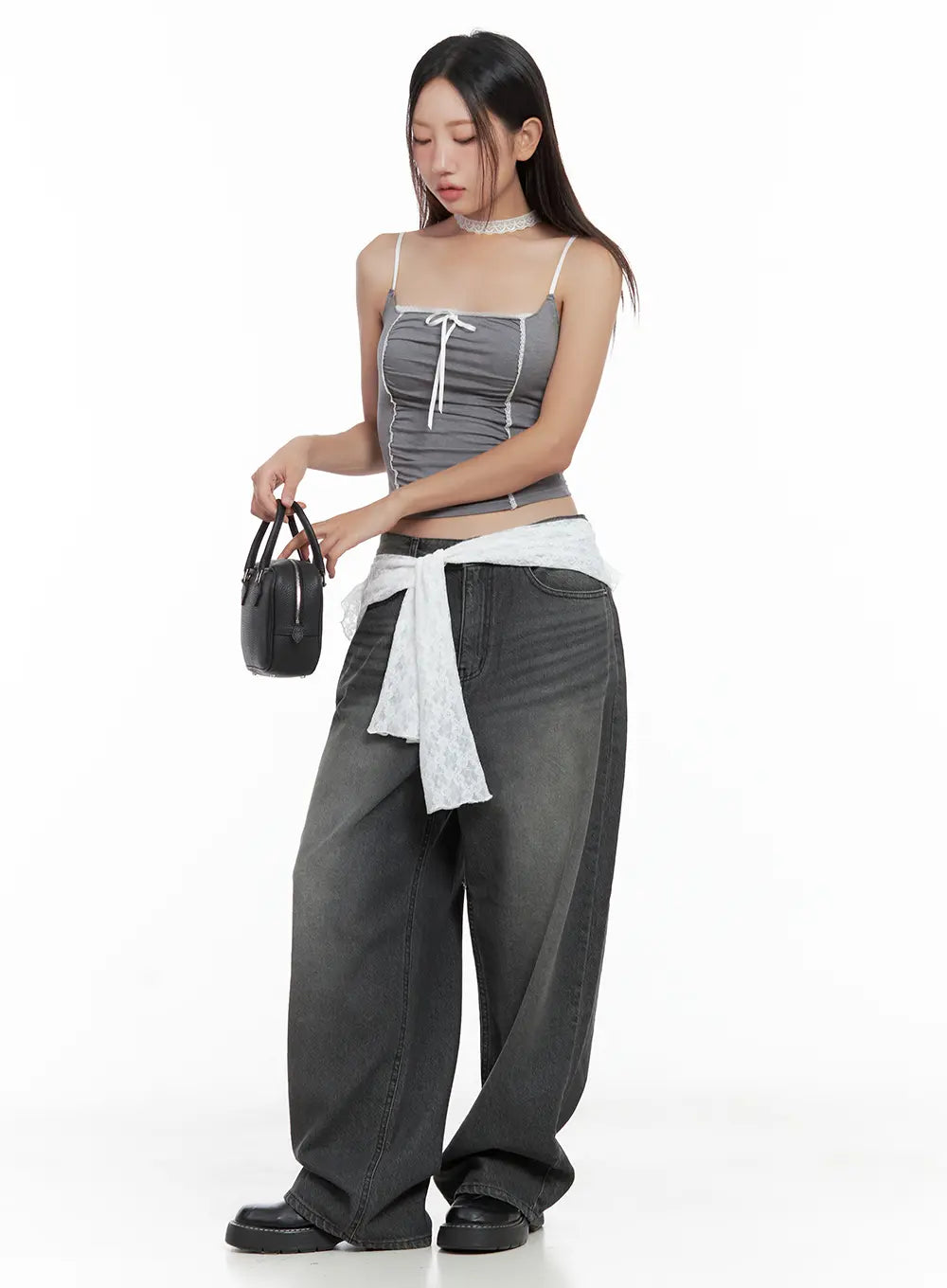 Kumi Washed Wide-Leg Summer Denim Jeans CL508 in Black, three-quarter front view on model, wide-leg washed cotton denim, styled with grey cami top and white lace jacket tied at waist, holding mini bag.