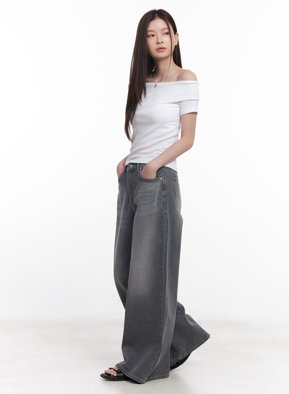 Beatriz Washed Wide-Leg Jeans CY519 in gray, full-body side shot on model, wide-leg silhouette with hand in pocket, paired with white off-shoulder top and black sandals.