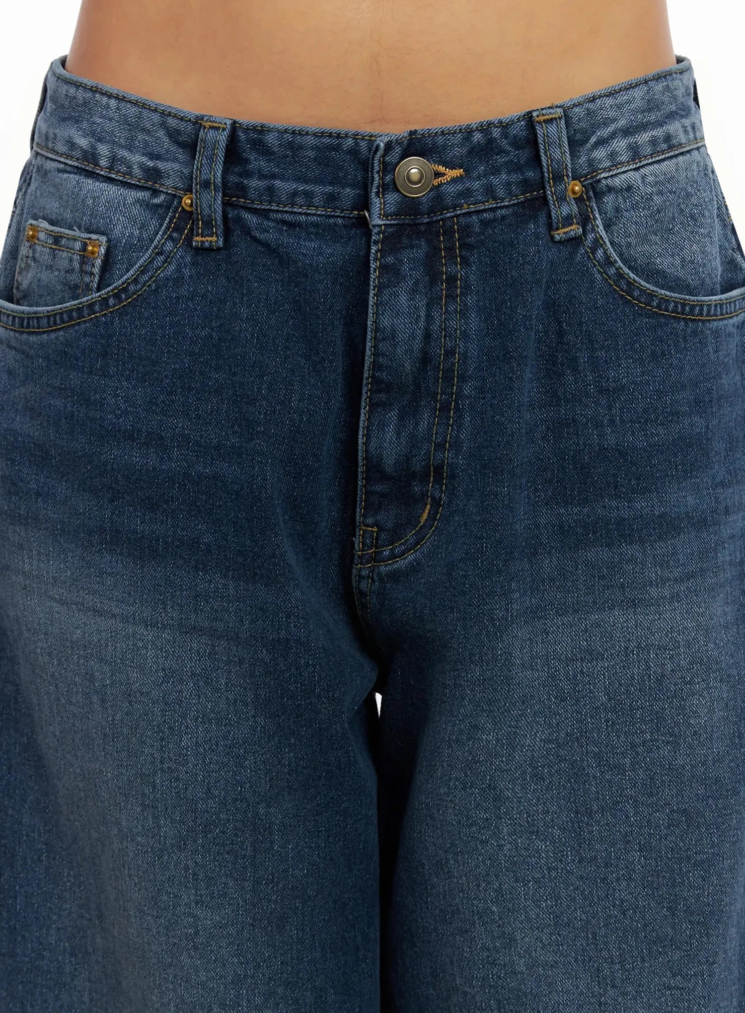 Anahi Baggy Jeans IN528 in blue, close-up detail of waistband and front pockets, showing brass button closure, gold stitching, and washed cotton texture.