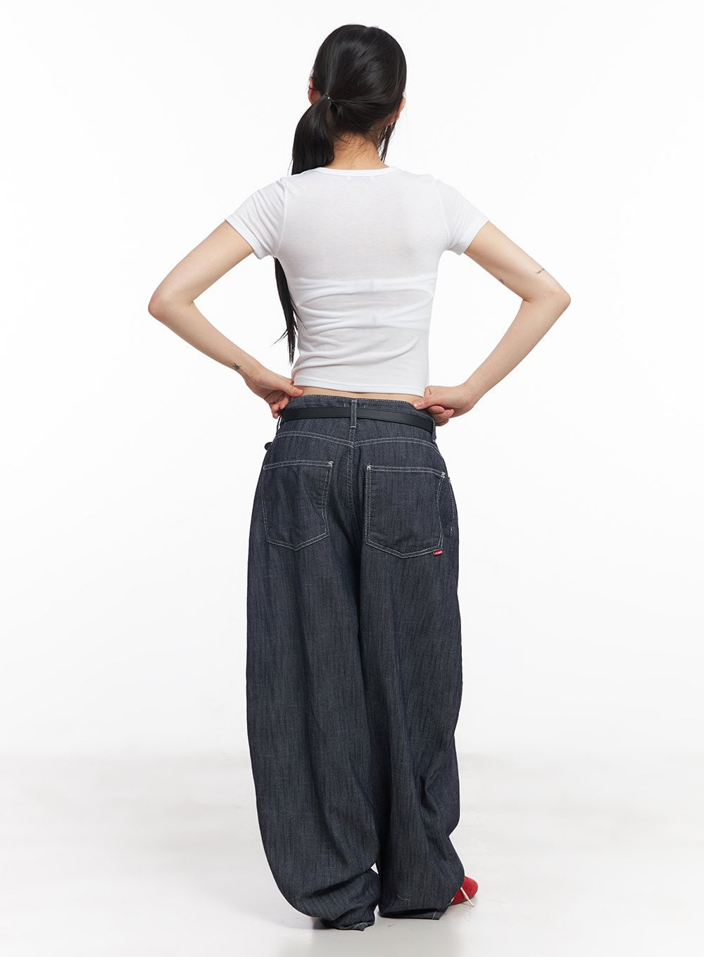 Isabel No-Fade Baggy Jeans CY514 in dark blue, back full-body view on model, showing square back pockets with contrast stitching, red brand tab, wide draped legs, belted waist.