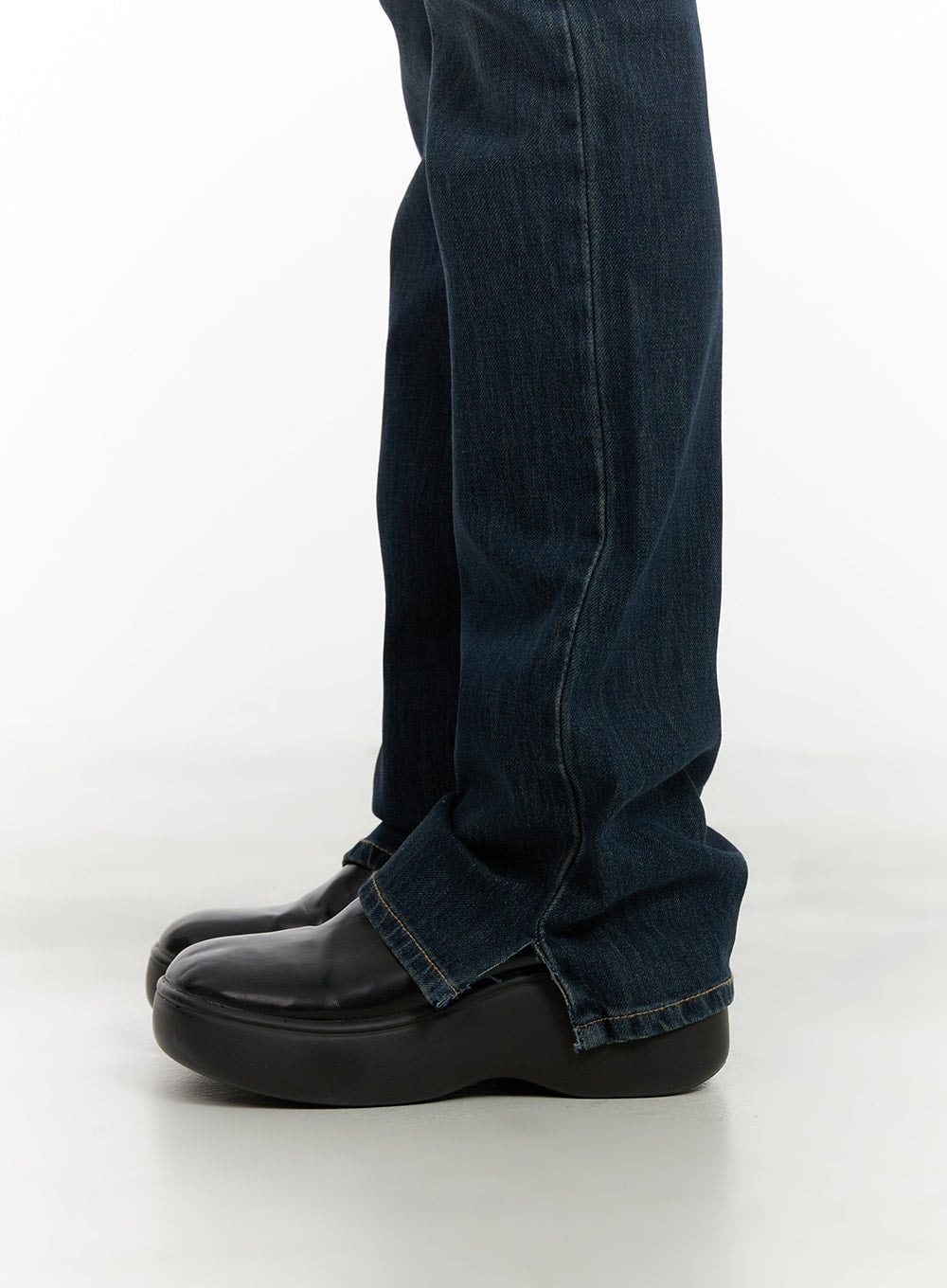 Slim Fit Bootcut Jeans CA418 in dark blue, close-up of hem and bootcut flare detail on model, washed denim fabric texture visible, styled with black platform loafers.