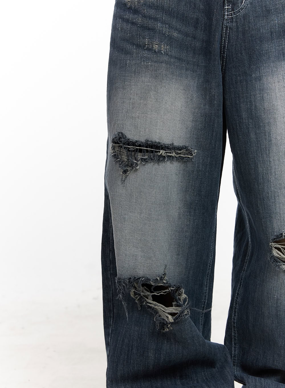Alison Destroyed Baggy Jeans CJ523 in dark blue, close-up detail shot of frayed rip tears on thigh and knee area, showing raw-edge distressed cotton denim texture.