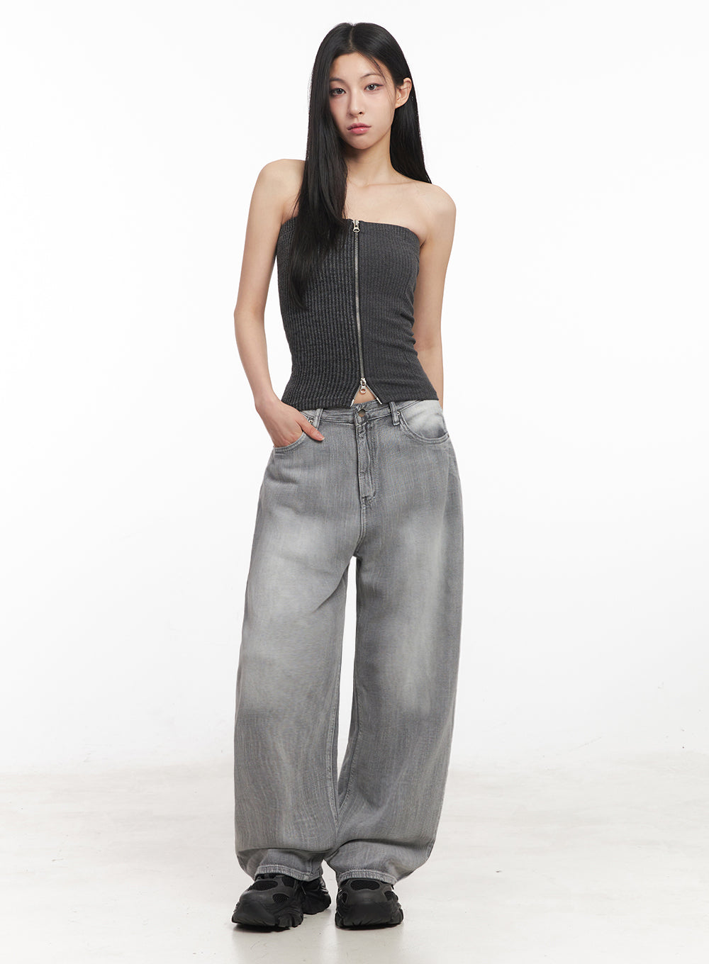 Flore Washed Wide-Leg Jeans IY516 in gray, full-body front shot on model, relaxed wide-leg fit with hands in pockets, paired with gray ribbed zip tube top and black sneakers.