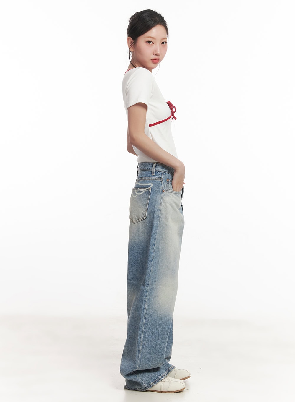 Lumira Back-Detail Washed Wide Leg Jeans CA530 in blue, side profile view on model, oversized wide leg silhouette with washed fade, side pocket visible, paired with crop tee.