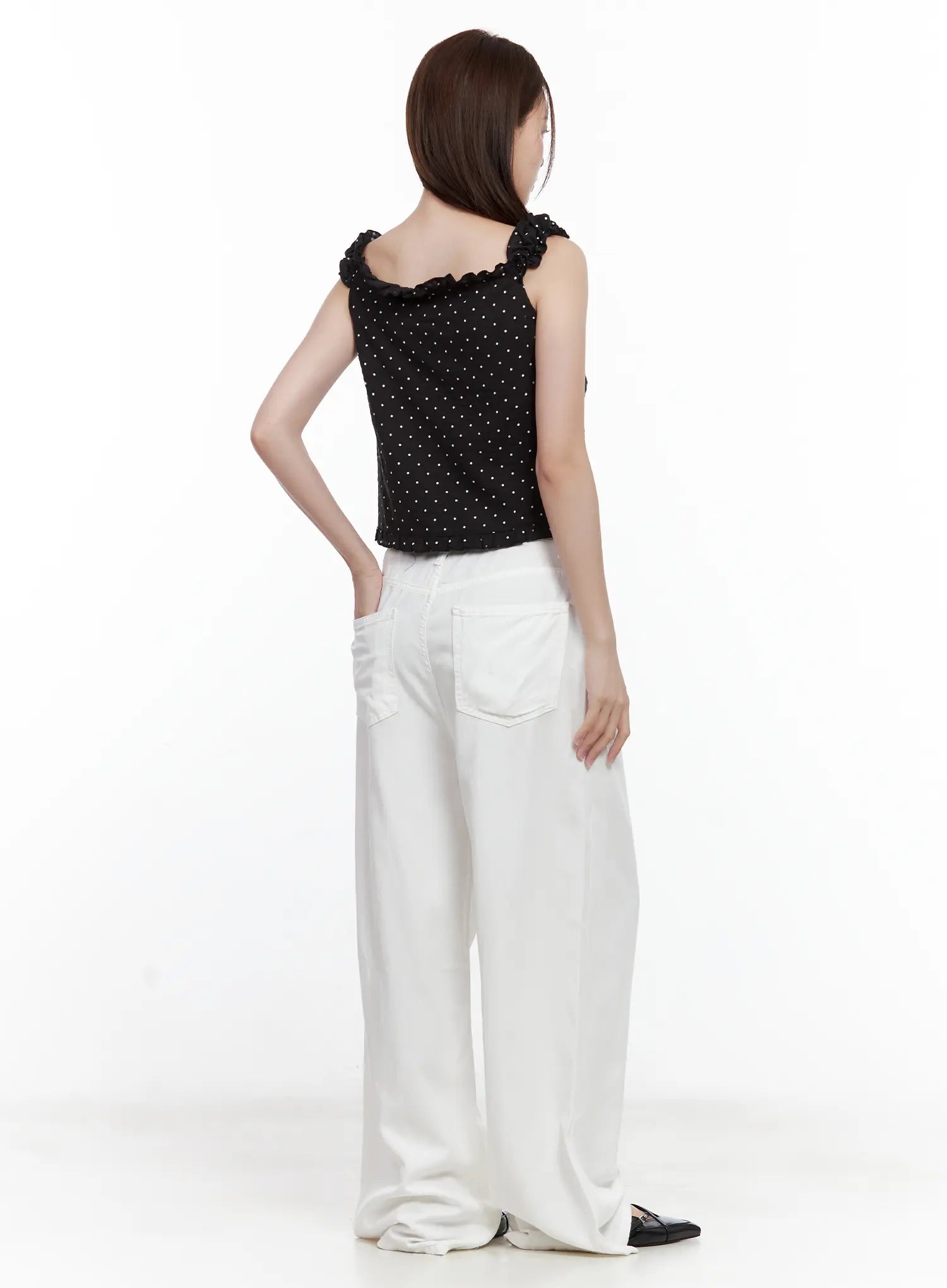 Jennie Baggy Wide-Leg Jeans CL502 in white, back view on model, large patch back pockets, wide-leg floor-length fit, styled with black polka-dot cami and black loafers.