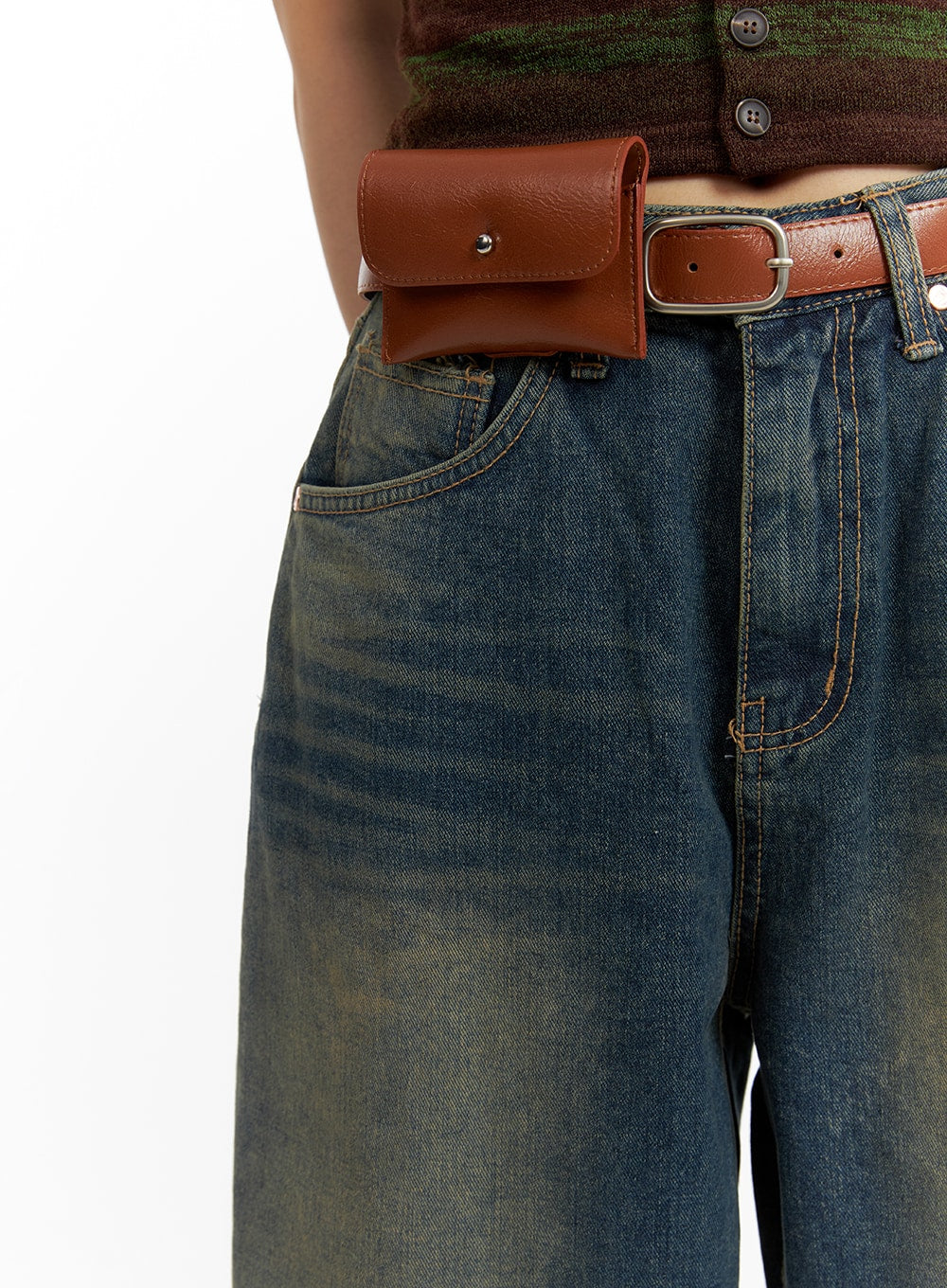 Scratch Textured Baggy Jeans CM405 in washed indigo blue, waist close-up on model, highlighting five-pocket construction and washed fading, styled with brown leather belt and mini belt bag.