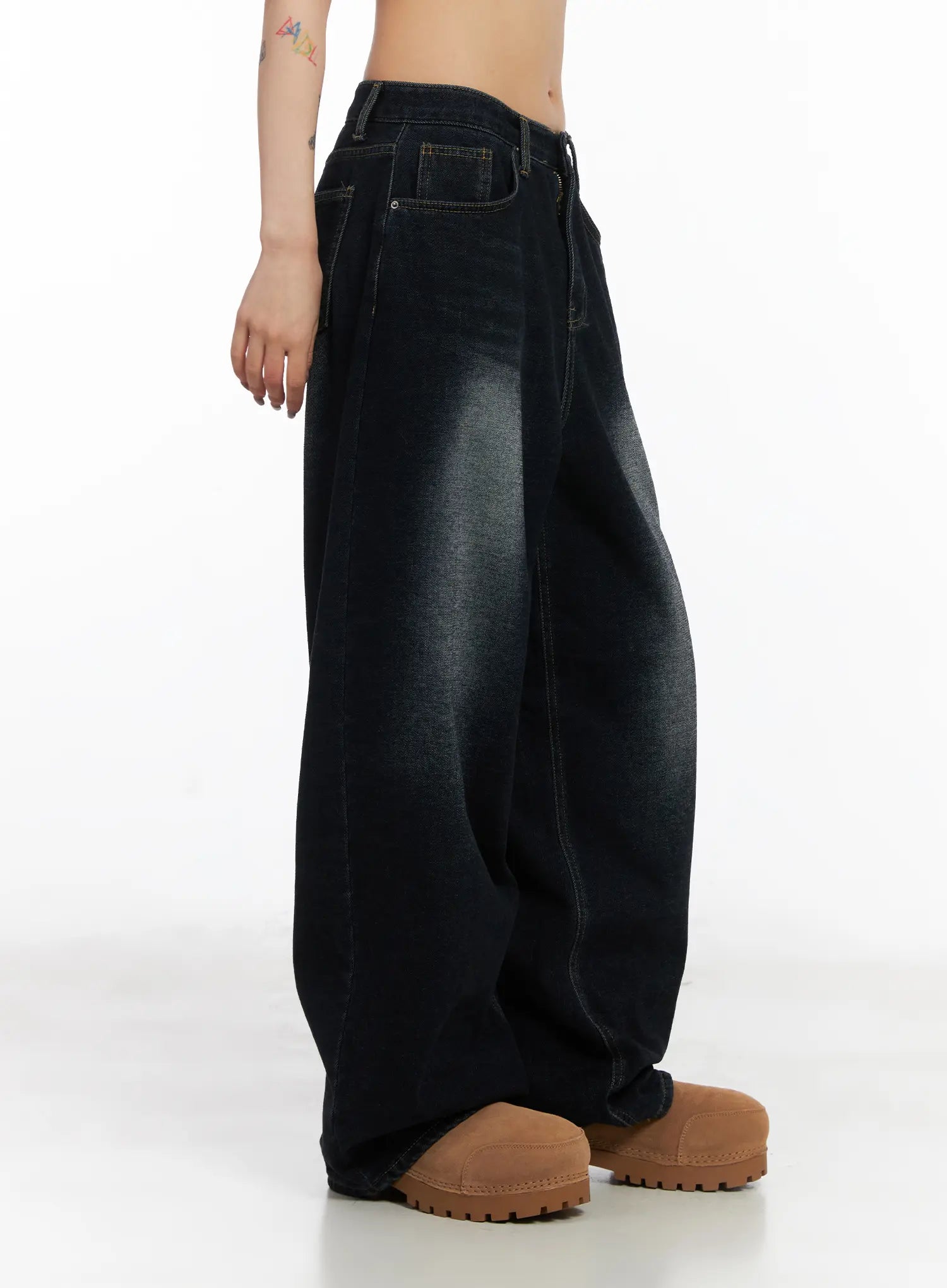 Soph Fleece-Lined Washed Wide-Leg Jeans CD509 in dark washed indigo, side view on model, highlighting voluminous wide-leg silhouette and faded wash gradient, worn with tan chunky boots.