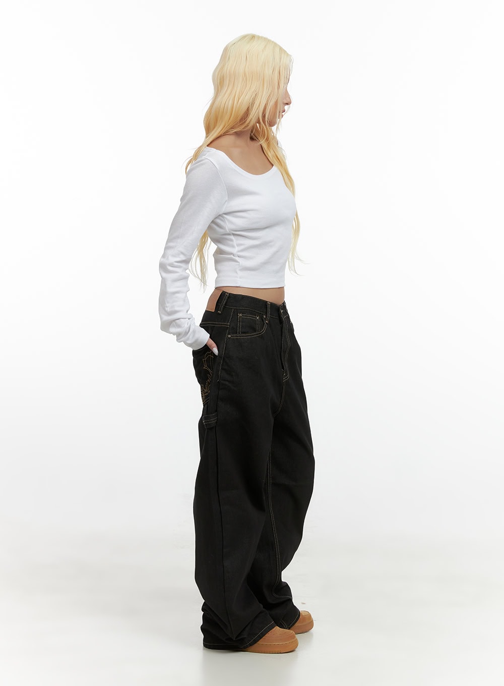 Mara Relaxed Fit Pocketed Cotton Wide Leg Jeans CS426 in black, full-body side view on model, relaxed wide-leg denim with visible embroidery on hip pocket, styled with white crop top and tan sneakers.