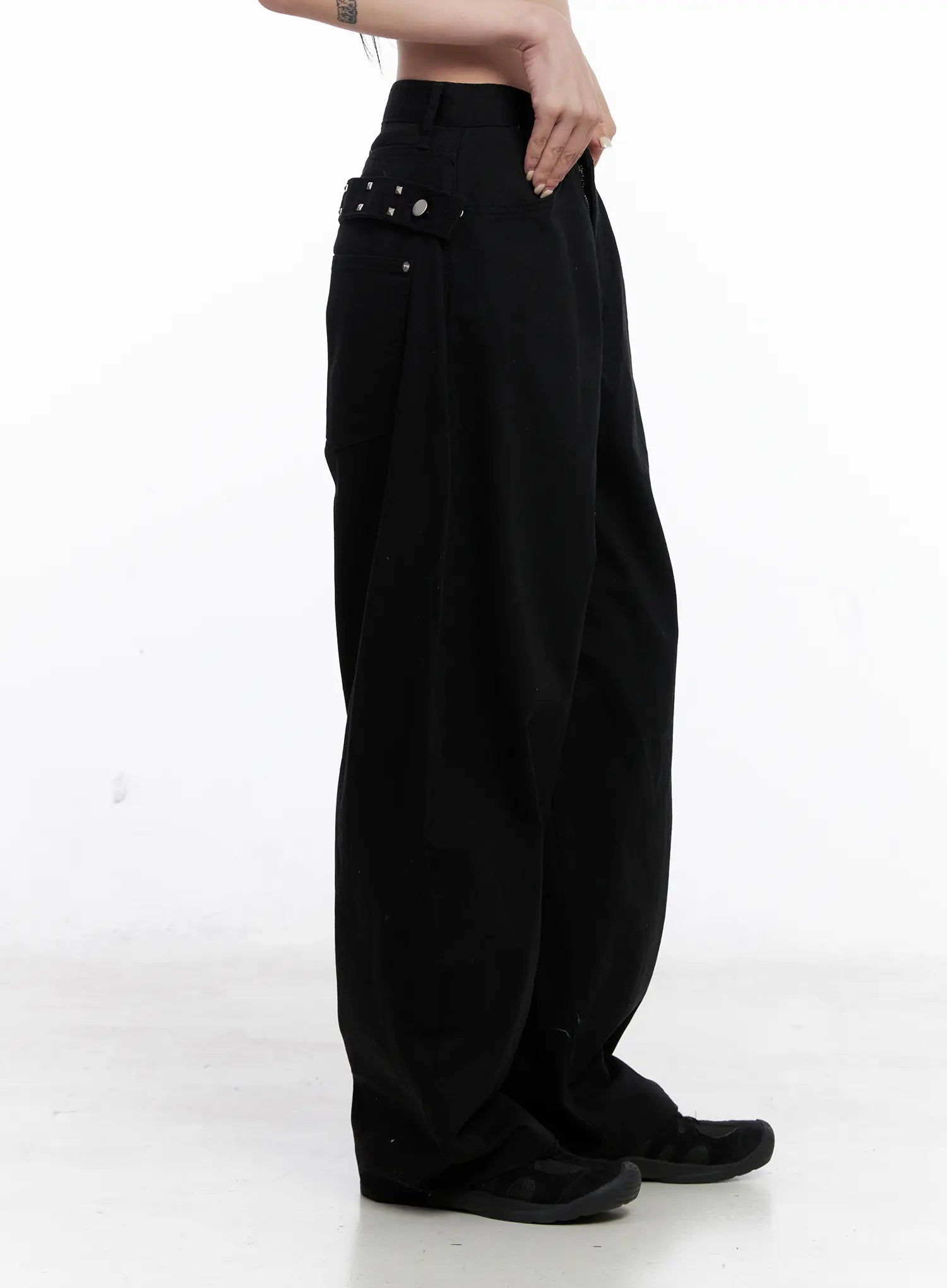 Nana Studded Belt Balloon Jeans CS512 in black, side view on model, balloon leg volume and studded belt detail at hip, long wide-fit cotton leg pooling at ankle.