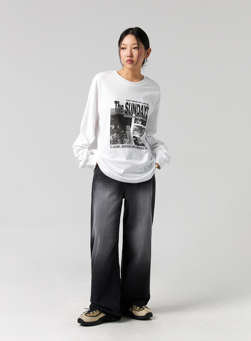 Washed Wide-Leg Jeans CG327 in black, front full-body shot on model standing straight, wide-fit washed cotton denim, high-rise waist, paired with oversized graphic long-sleeve tee and sneakers.