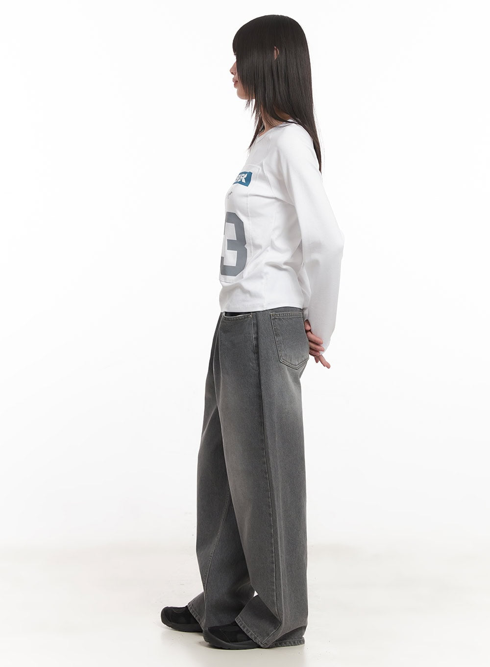 Venessa Washed Baggy Jeans CM528 in dark gray, side view on model, showing wide-leg silhouette and washed denim drape, styled with white graphic top.