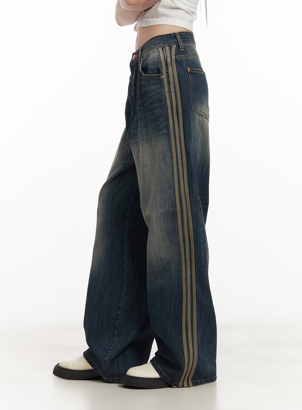 Daisee Striped Wide-Leg Jeans CF518 in dark blue, side full-length view on model, wide-leg washed denim with contrasting triple stripe running from waist to hem, white crop top.