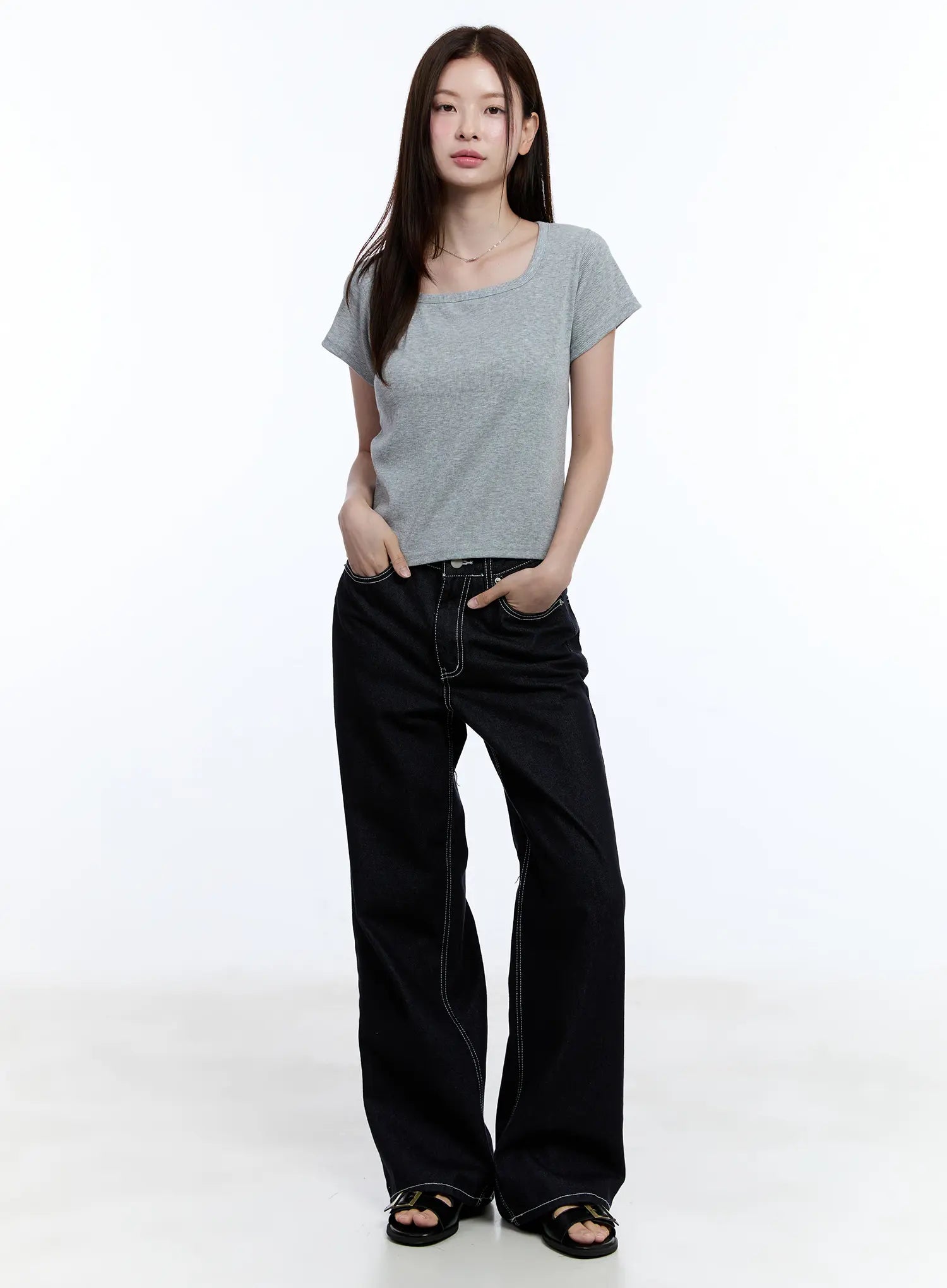 Nayeon No-Fade Denim Jeans CU513 in dark blue, full-body front view on model standing straight, wide-leg fit with contrast stitch detail, styled with grey tee and black sandals.