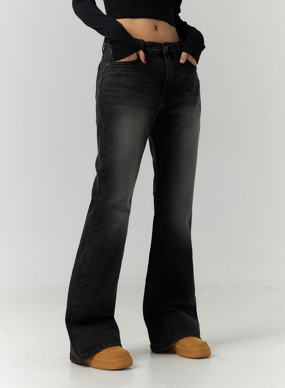 Low Rise Bootcut Jeans CD304 in black, close-up front waist-to-hem shot on model, low-rise button fly, washed fading detail, slim thigh tapering into bootcut flare at ankle.