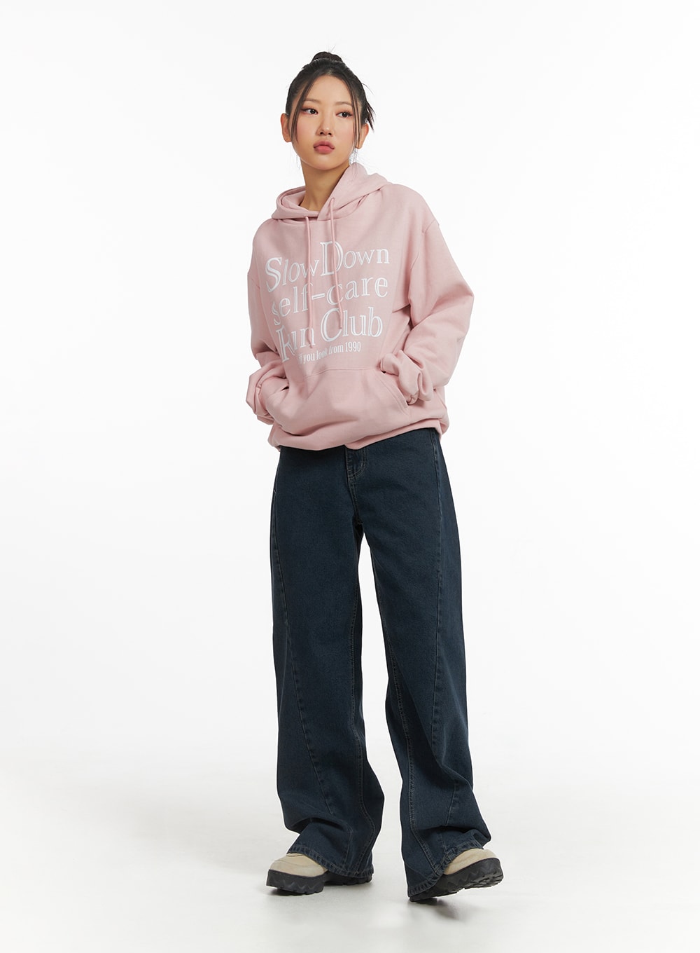 Washed Wide Leg Jeans CJ429 in dark blue, three-quarter front shot on model with slight angle, wide leg denim pooling at hem, styled with pink hoodie and bun updo.