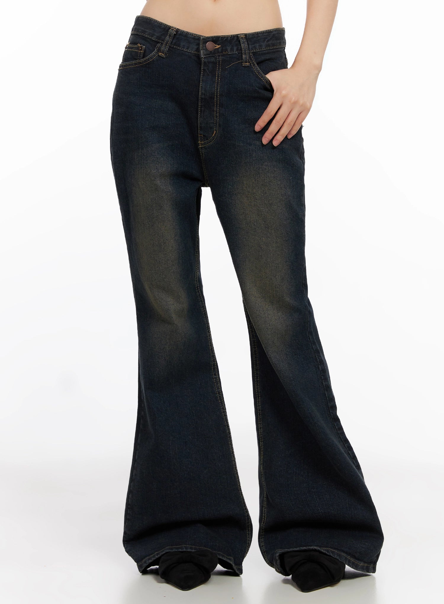 Lyanna Vintage Wash Bootcut Jeans IN503 in dark blue, front three-quarter view on model, hand on hip, low-rise waist and flared bootcut silhouette with golden wash fading.