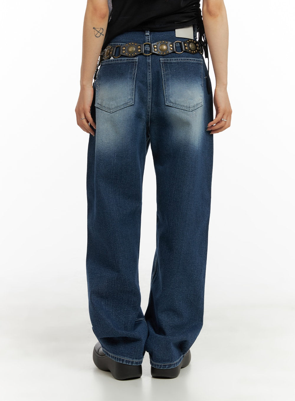 Splash Paint Baggy Jeans CA408 in blue, back view on model, wide-fit washed denim with two back patch pockets and contrast stitching, styled with studded belt.