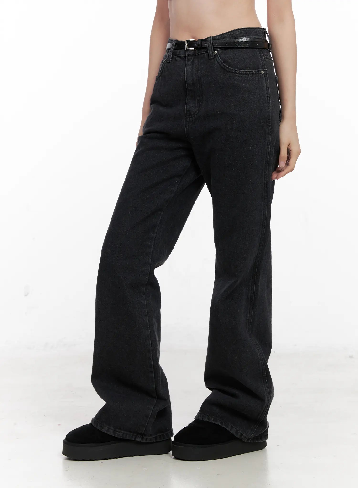 Eileen Belted Flare Jeans CN504 in washed black, front side view from waist to hem on model, showing loose flare silhouette and long length, paired with black platform slides.