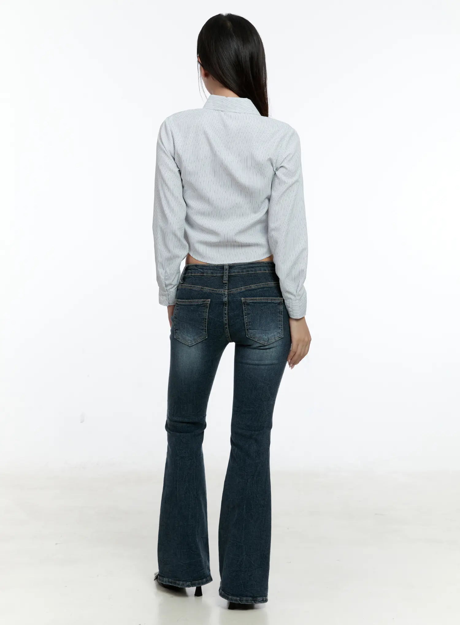 Harlee Bootcut Jeans CS517 in dark blue, back full-length view on model, showcasing dual back pockets with washed detailing and flared bootcut hem, paired with a cropped stripe top.