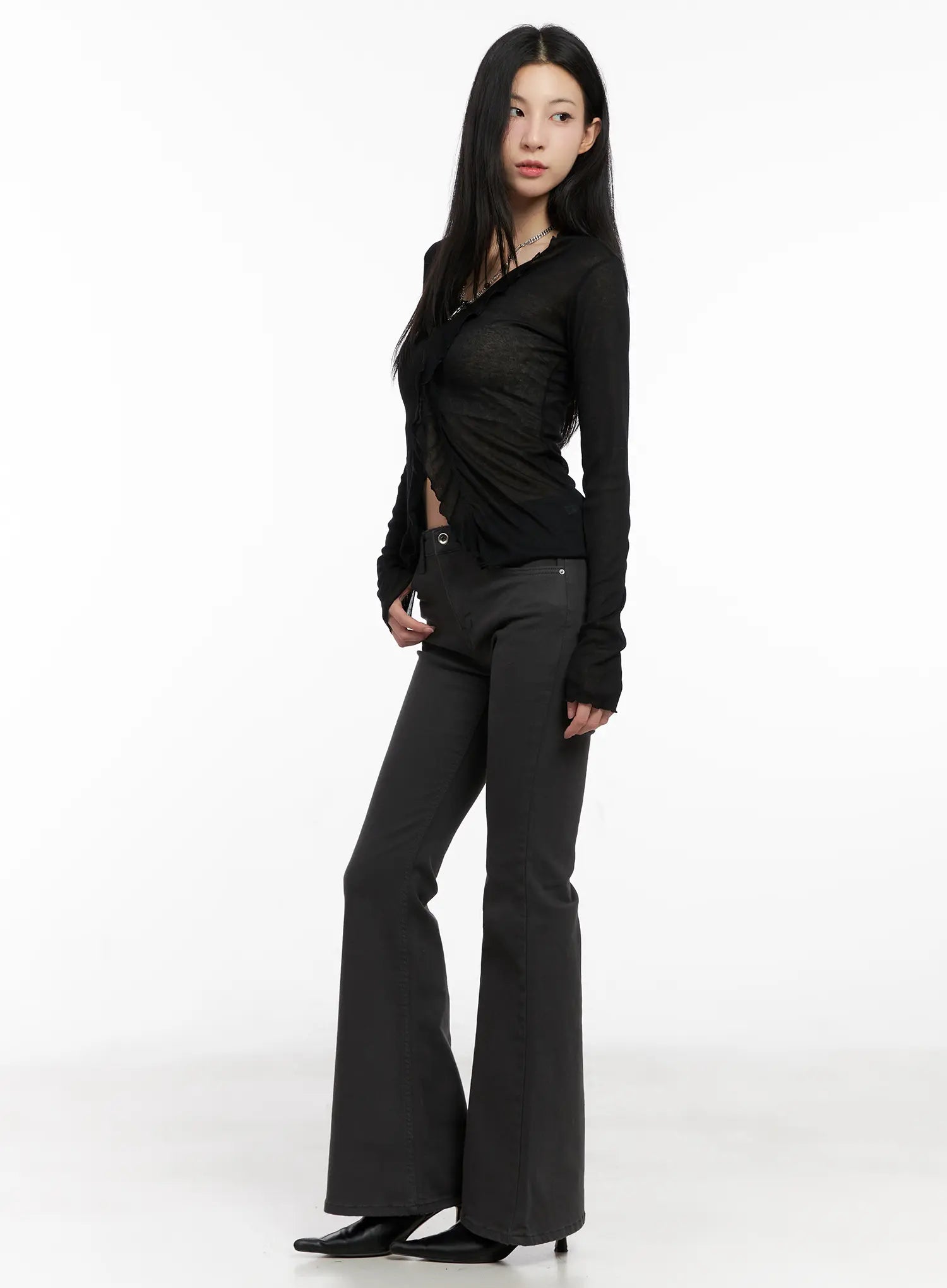 Addie Chic Flared Jeans CG522 in dark gray, side view on model, slim fit with subtle flare from knee, mid-rise waist, cotton-spandex stretch, paired with black sheer cardigan.