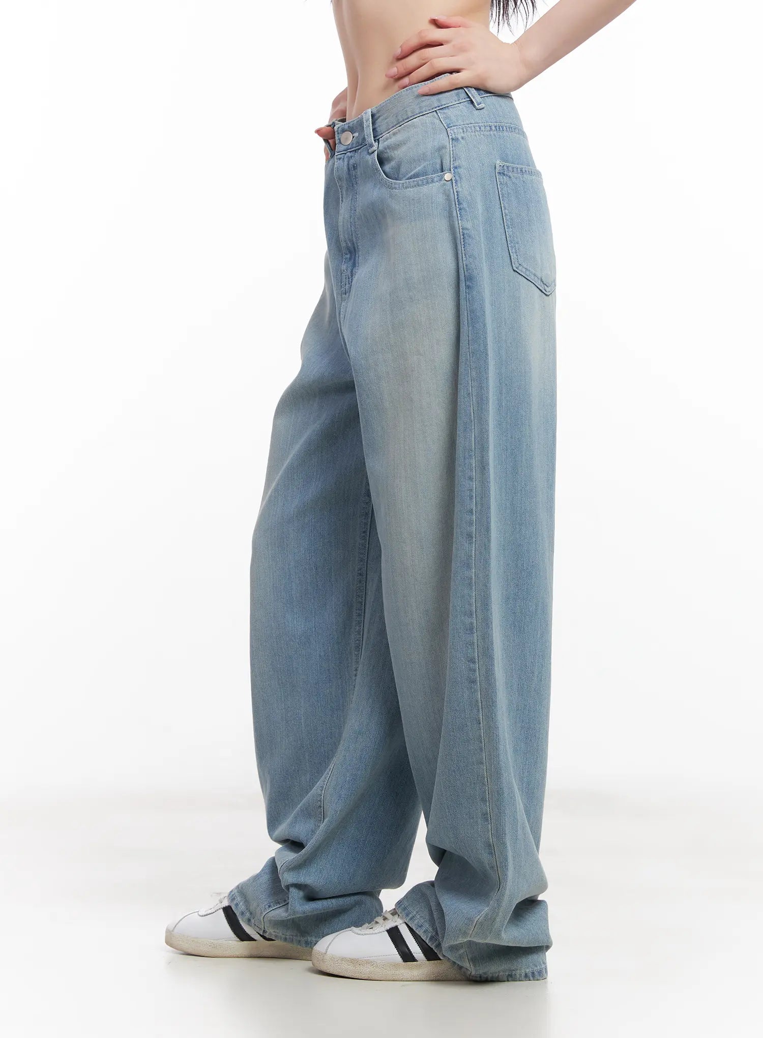 Rose Washed Baggy Summer Denim Jeans CU511 in light blue, side view crop on model, wide-leg washed denim showing back pocket detail and relaxed silhouette, styled with white sneakers.