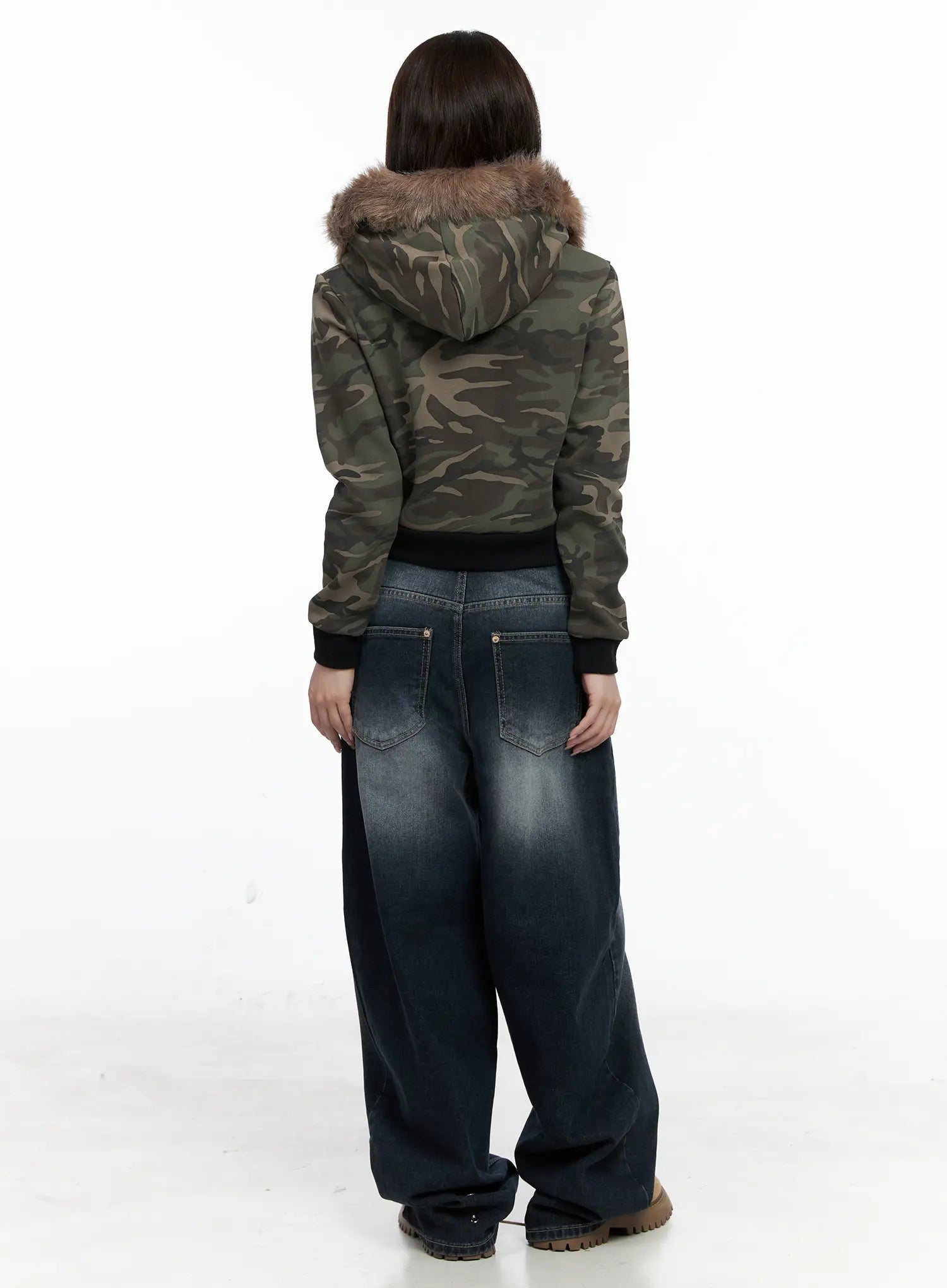 Isla Washed Baggy Jeans CO521 in dark blue, back view on model, showing dual back pockets with contrast stitching and voluminous wide-leg hem, paired with camo fur-trim jacket.