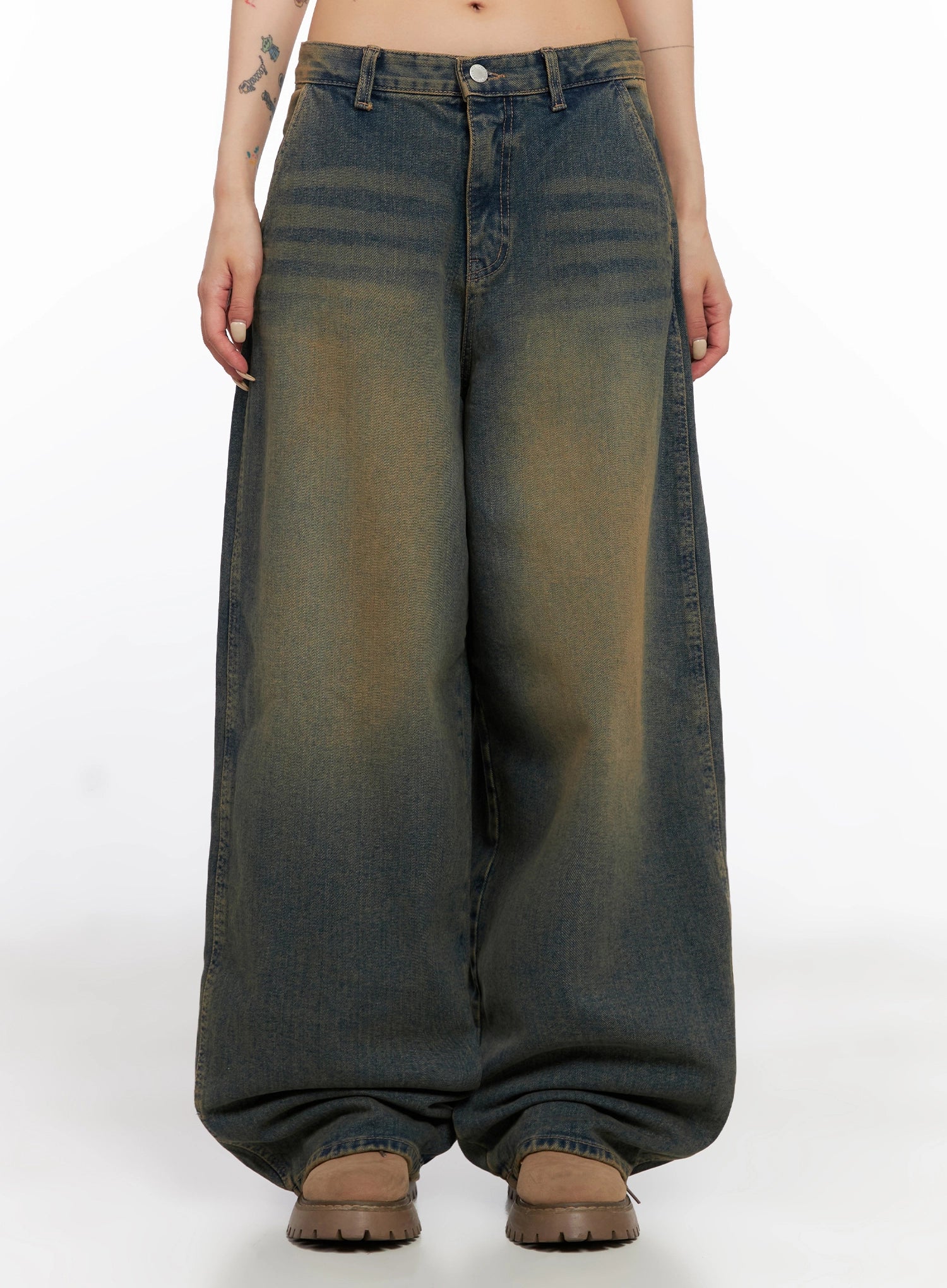 Minju Vintage Washed Baggy Jeans IS508 in dark blue, front product-style shot on model, maxi length, heavy volume wide leg pooling at hem, yellow-tinted vintage wash, brown boots.